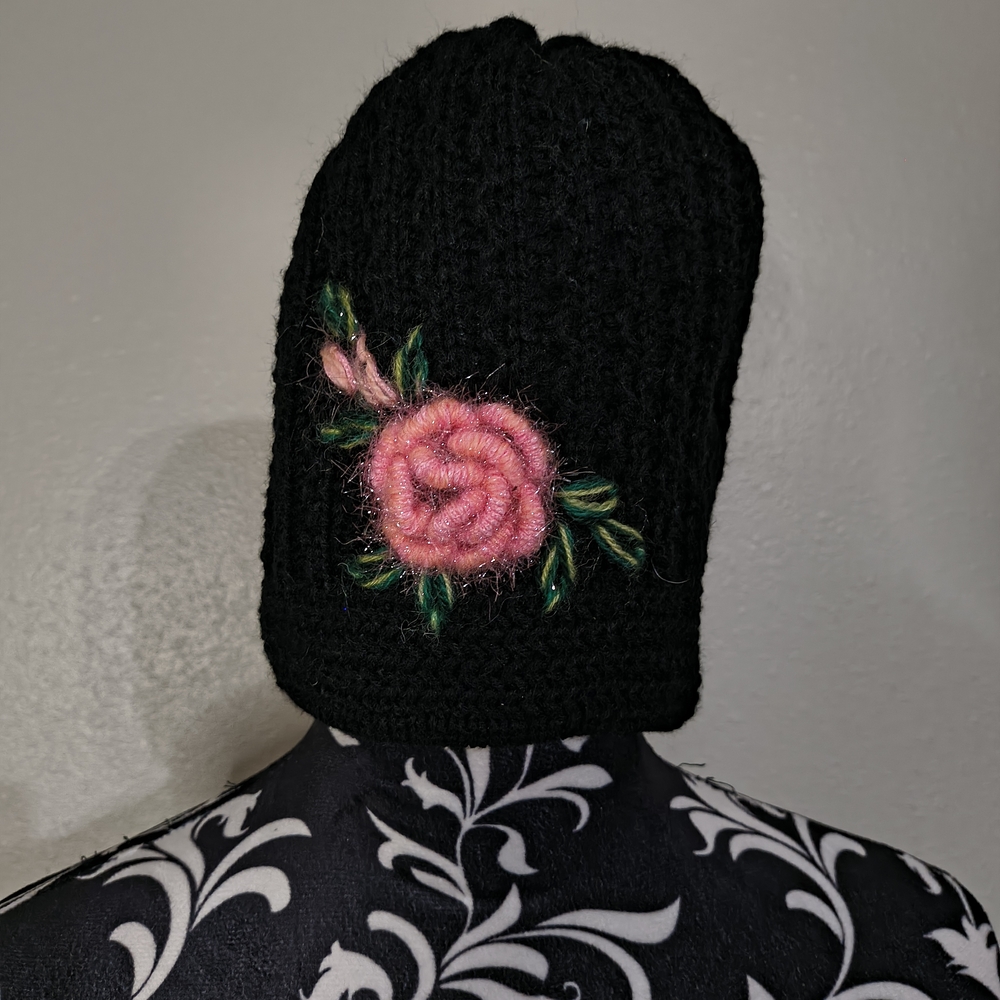 Elegant Black Hat with Pink Floral Accent